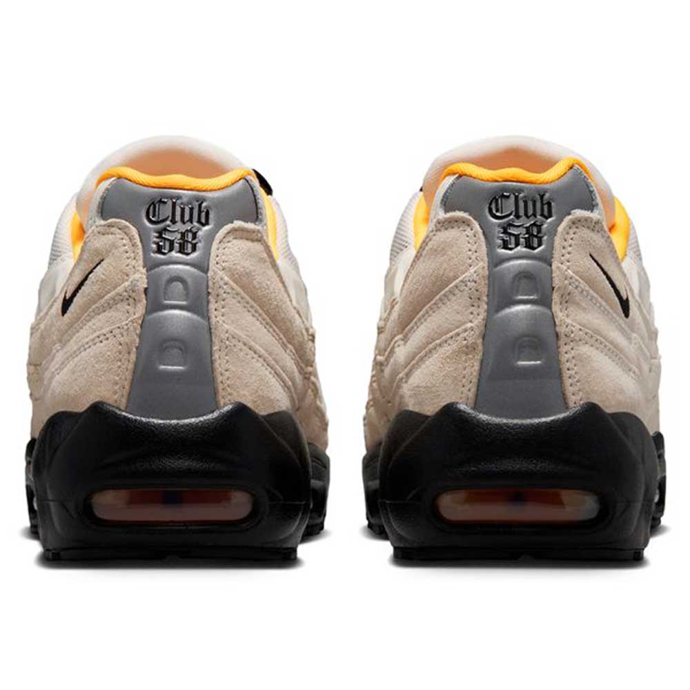Rear view of a pair of Air Max 95 Sail Black Laser Orange Nike SB skateboarding shoes, featuring beige and gray tones, black soles, orange inner lining, and Club 58 stitched in black on the heel area.