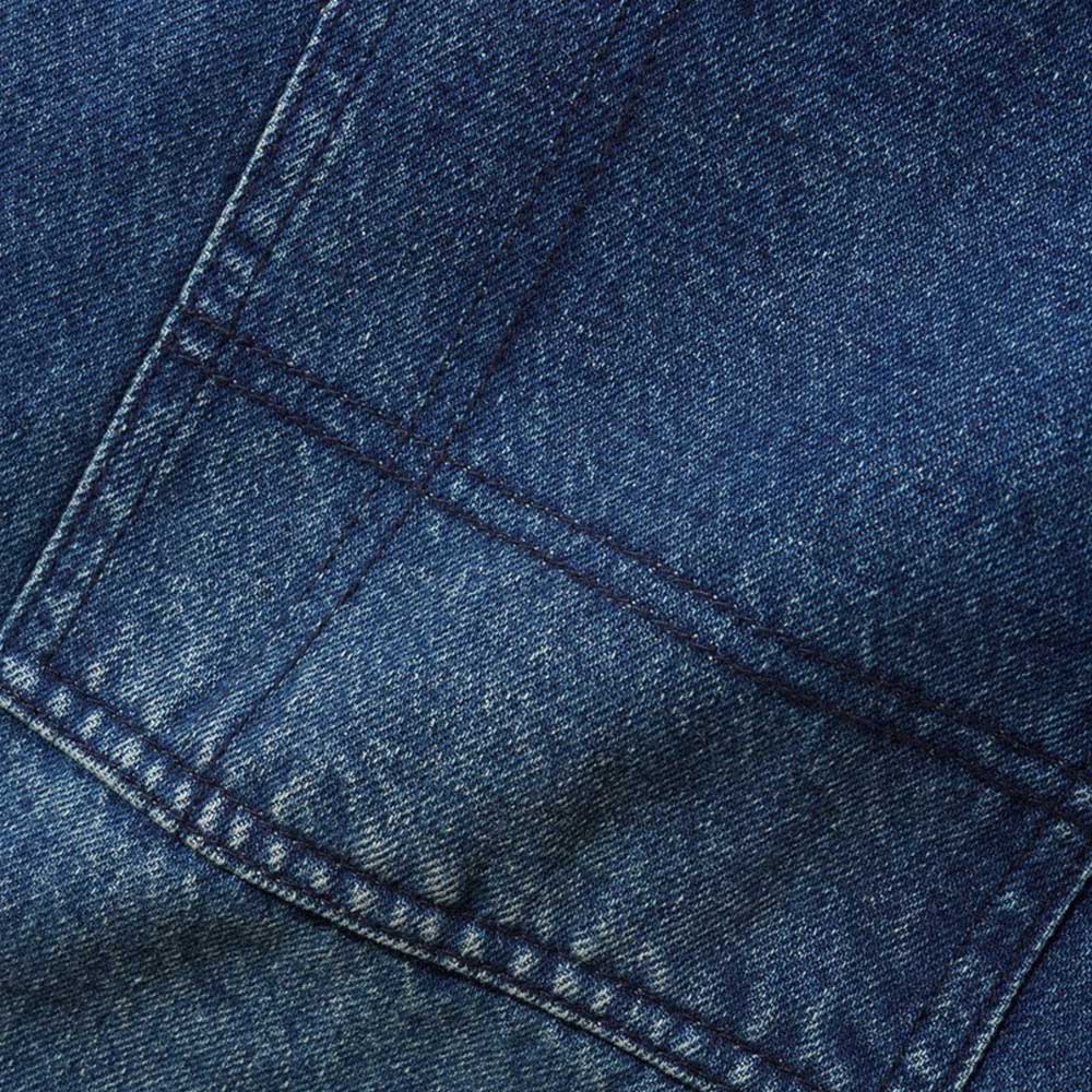 Close-up of Aleka Dark Indigo Denim Jeans by Butter Goods, showcasing blue cotton denim fabric, visible stitching, sturdy seams, and the textured weave that reflects their signature loose fit and durable construction.