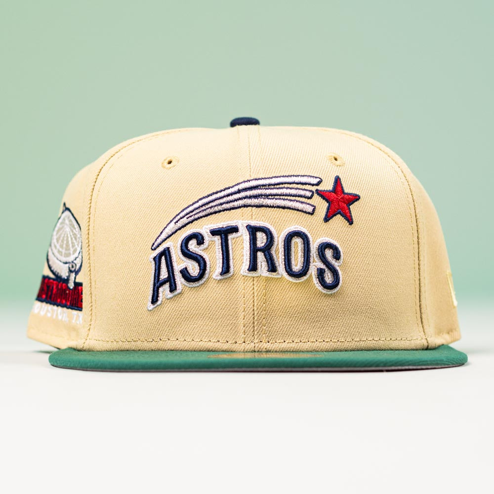 The New Era Hat 5950 Houston Astros Vegas Gold Emerald Aeros 5950 Day features "ASTROS" in bold, a red star with a comet, an Astrodome sidepatch, and a green brim against a light green background.