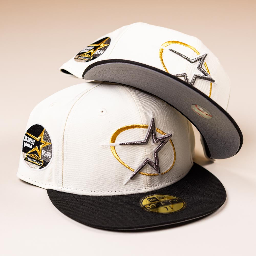 Two White Black Circle Star Houston Astros New Era 5950 Fitted Hats are stacked, each with a black brim, gold and silver embroidered star front, side star patch, and a “7 1/4” 5950 size sticker.