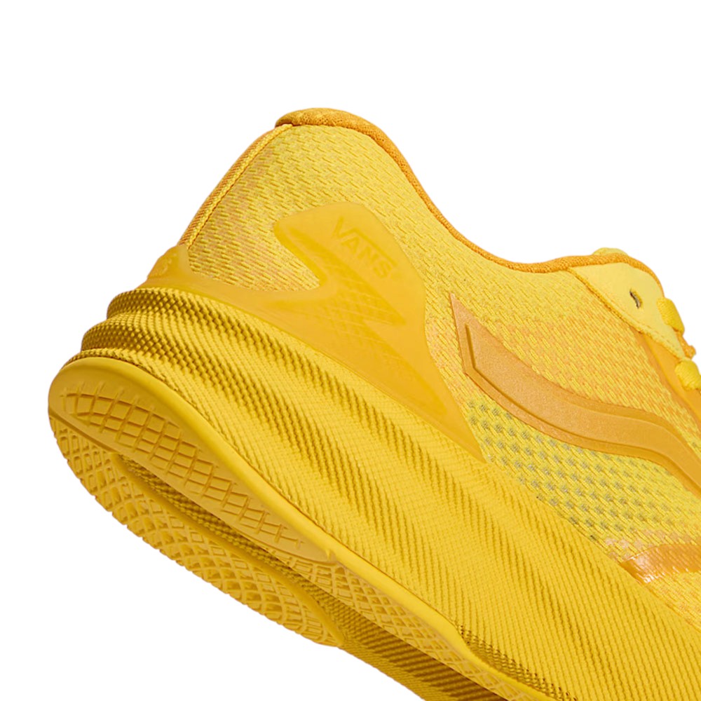 Close-up of a yellow Atiba Vans AVE Rapid LX Gold VN000Y1MGLD Suede Skateboarding Shoe, highlighting the textured heel, FeatherKnit construction, midsole, and branded heel overlay.
