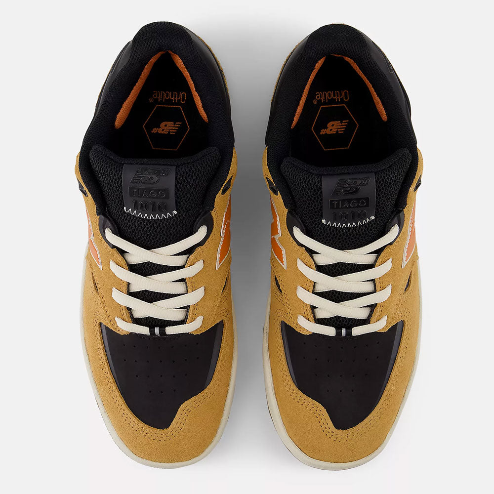 The Baked Clay Black 1010 LV New Balance Numeric Suede Skateboarding Shoes feature tan suede, black toe boxes, orange accents, white laces, and black lining—shown from the top side by side on a white background.
