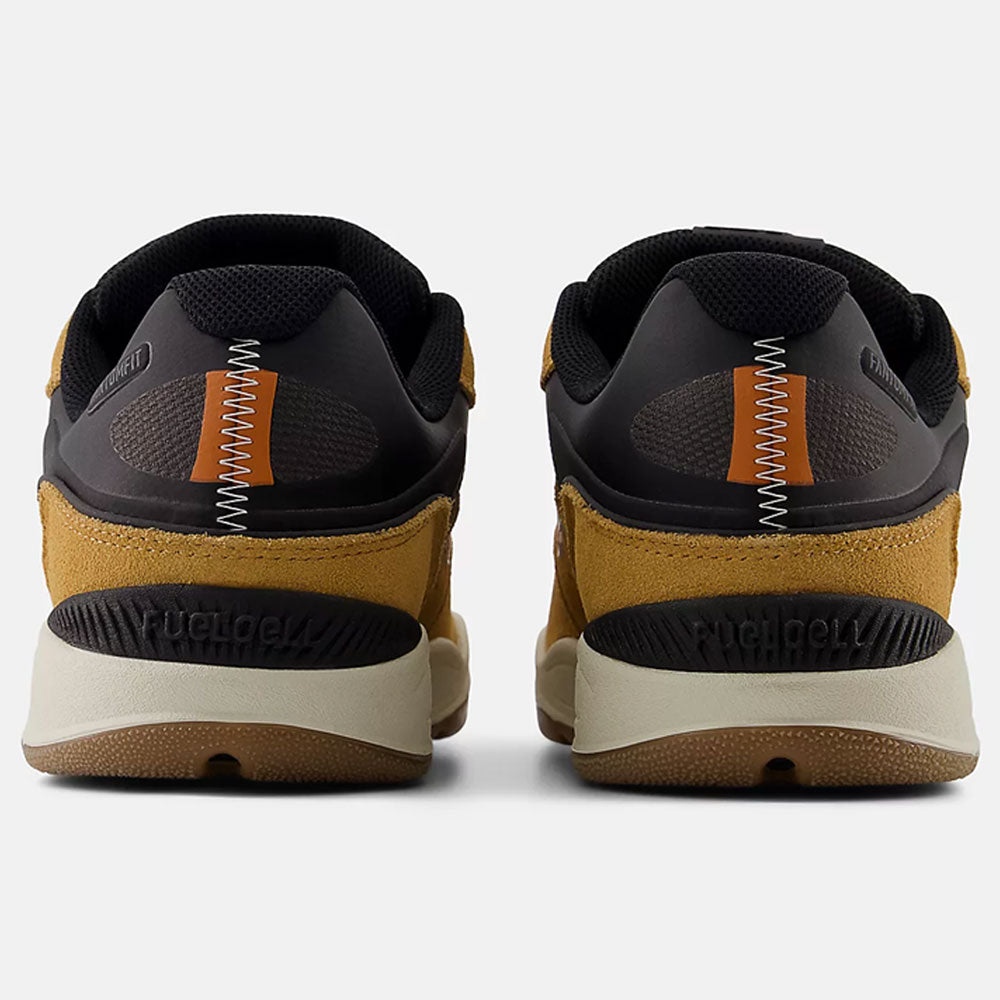 Rear view of Baked Clay Black 1010 LV New Balance Numeric suede skateboarding shoes, featuring brown suede, black mesh accents, orange and white zigzag stitching, beige soles, and pro-level skate shoe performance.
