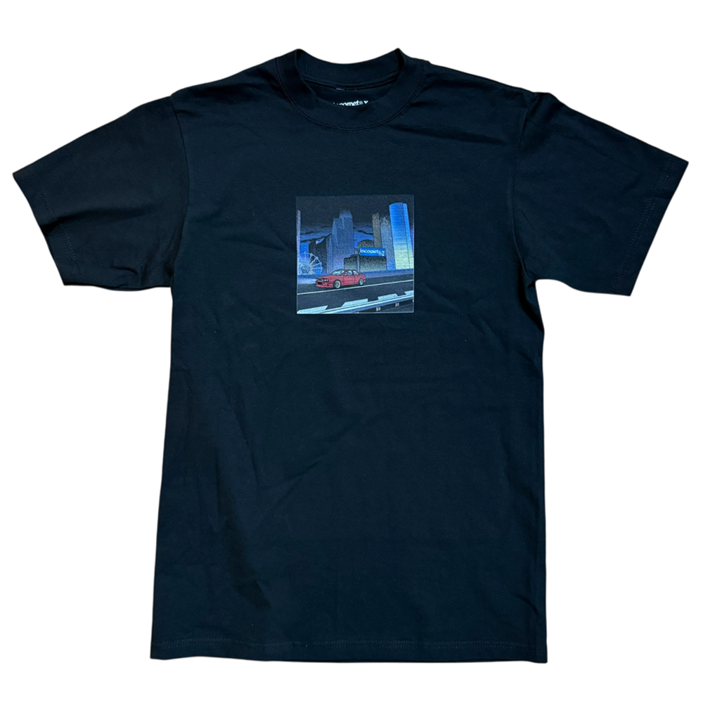 The Beemer Tee Black Income Taxes is made from premium USA cotton and features a red car cruising through a futuristic cityscape with glowing blue lights—a perfect streetwear pick for fans of bold graphics.