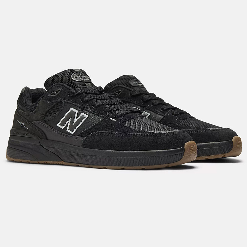 The Black 933 NAP New Balance Numeric Suede Skateboarding Shoes feature suede and mesh uppers, white outlined N logos on the sides, and brown rubber outsoles, shown on a plain light background.