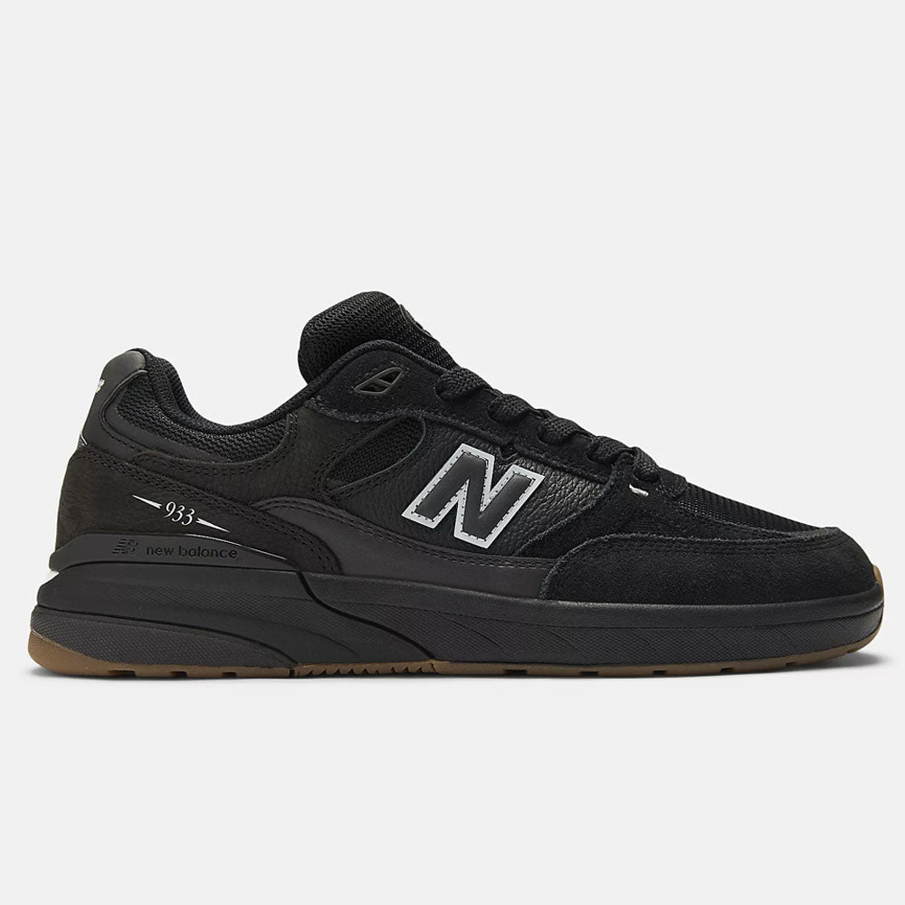 The Black 933 NAP New Balance Numeric Suede Skateboarding Shoes feature a white N logo, black laces, suede and mesh upper, and a gum rubber sole, displayed in side profile on a plain light background.