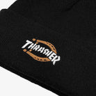 A close-up of the Black Beanie Thrasher Magazine x Dickies Skateboarding A8KV BLK, a black knit fisherman's beanie with "THRASHER" in white and a brown horseshoe embroidered logo on the front.