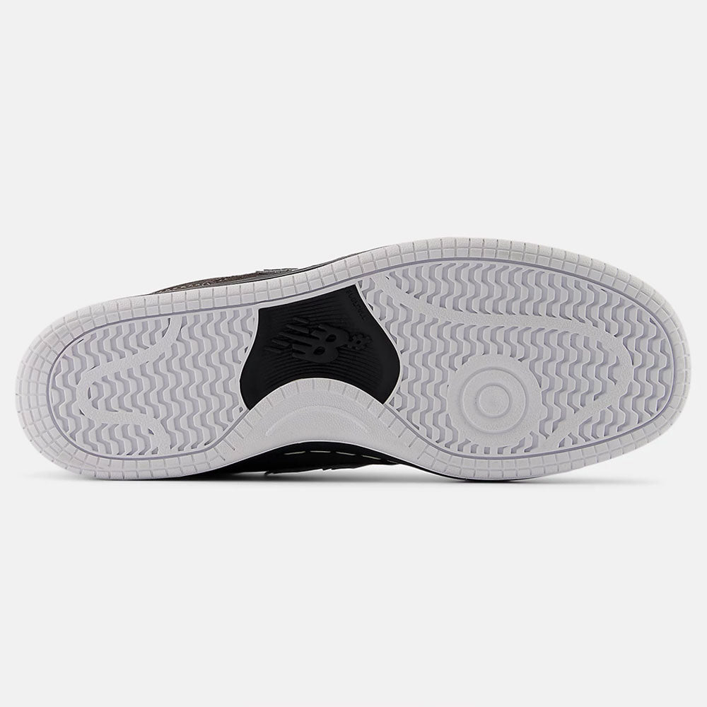 The image shows the black and white sole of the Black Cement 480 CSS New Balance Numeric Suede Skateboarding Shoes, featuring a wave-like tread, FuelCell foam cushioning, and an embossed New Balance logo in the center.