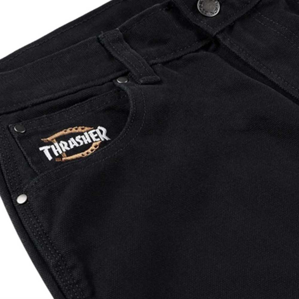 Close-up of the Black Duck Pant Thrasher Magazine x Dickies Skateboarding A88OP BLK, featuring a relaxed fit, small Thrasher flame logo patch above the front pocket, silver rivets, and classic waistband button.