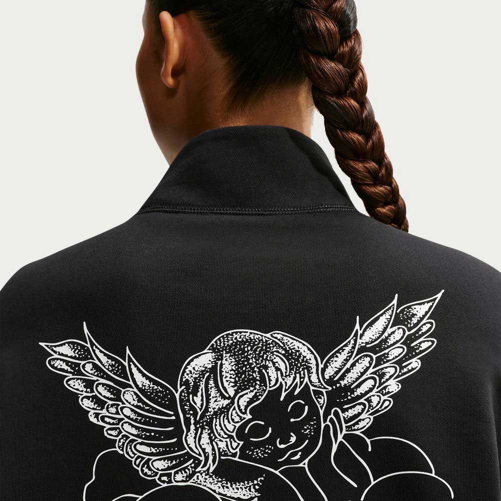A person with a long, braided ponytail is seen from behind, wearing the Nike SB Skateboarding Black IM5463010 Skate 1/2 Zip Fleece Crew, which features a white illustrated angel with wings and clouds on the back.
