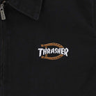 The Black Jacket Thrasher Magazine x Dickies Skateboarding A88CE BLK features stonewashed canvas, a left zipper, and an embroidered white "Thrasher" front graphic outlined by a brown horseshoe.