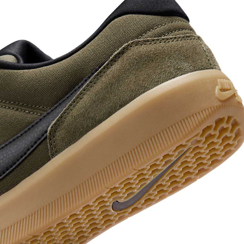 Close-up of the heel and sole of the Black Medium Olive IQ8398200 Force 58 Nike SB Suede Skateboarding Shoes, showcasing basketball-inspired design elements and a tan gum cupsole with textured Nike logo.