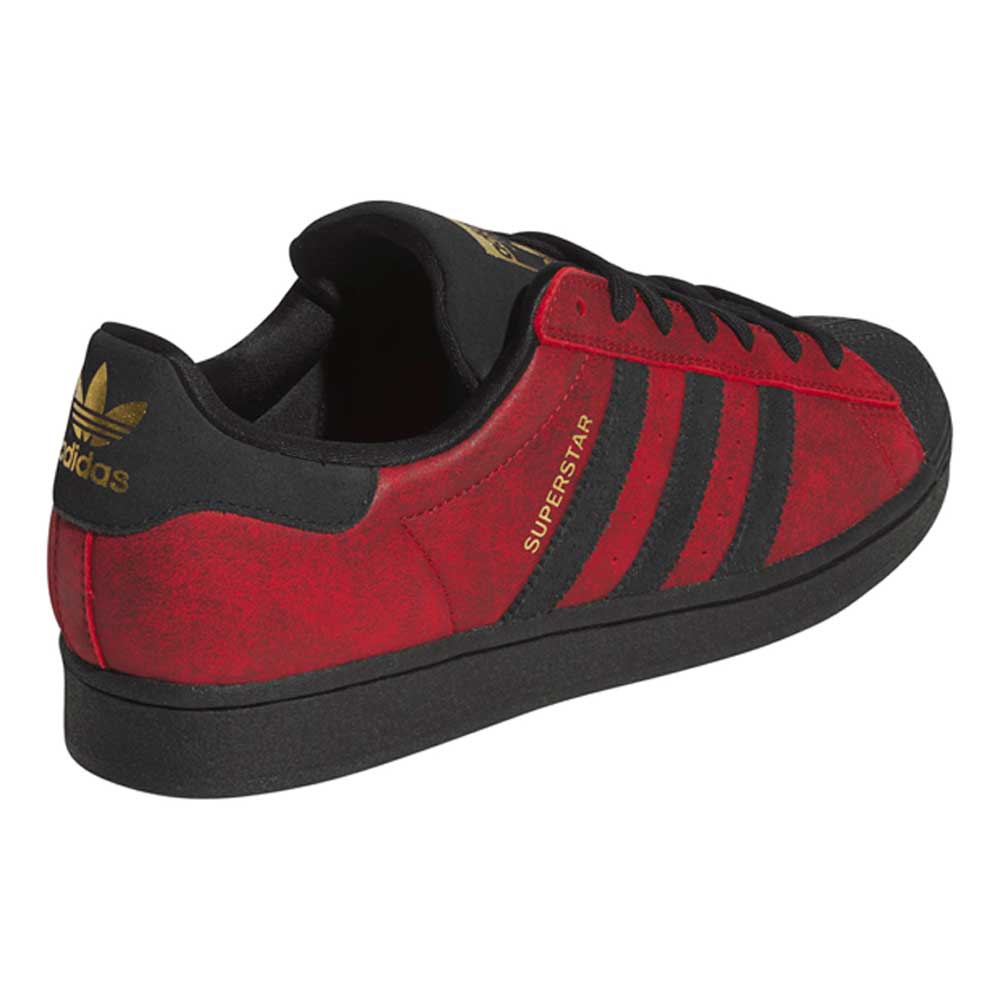 Sure! Here’s a rewritten version of your sentence using the provided product data: The Black Red Fog KJ5118 Superstar Adidas Skateboarding Suede Shoe features a striking red and black color scheme with gold accents, including black stripes and the “SUPERSTAR” text in gold on the side. A gold adidas logo highlights the heel, merging classic style with performance-driven details perfect for skateboarding footwear.