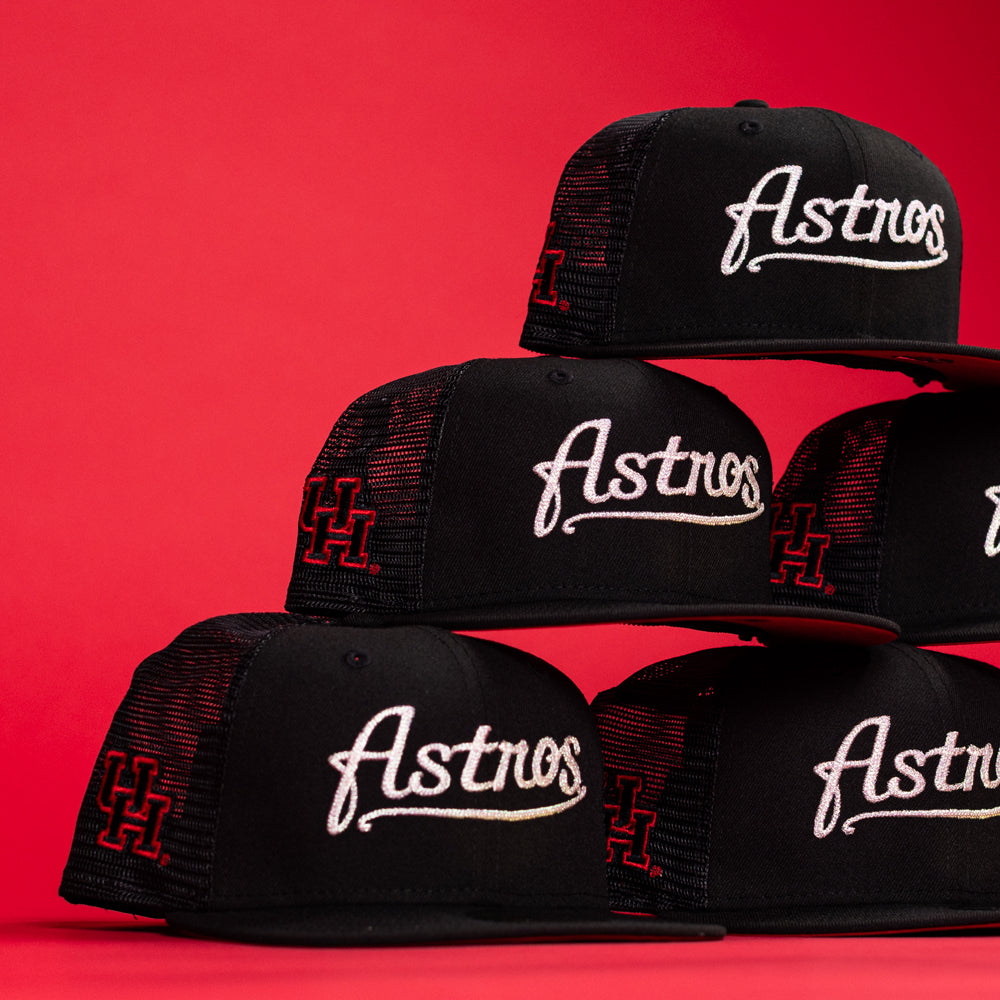 Five Black Scarlet Trucker Houston Cougars New Era 5950 Fitted hats with mesh backs are stacked against a red background, featuring “Cougars” in white script and a red H logo outlined on the side.