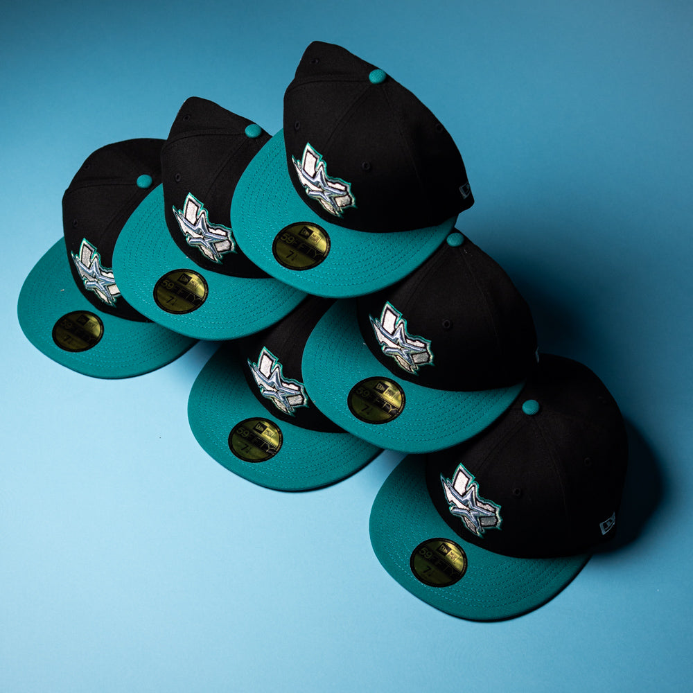 Six Silver Lining Black Teal 2000 Houston Astros New Era 59FIFTY fitted hats, each featuring Chrome Black gold stickers and embroidered white Houston Astros logos, are arranged in a pyramid shape on a light blue background.