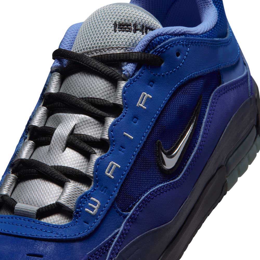 Close-up of Blue Void Metallic Silver IR1887400 Air MAX Ishod Nike SB skate shoe, with black laces, textured gray tongue, silver Swoosh, "W AIR" on the blue upper, and enhanced Max Air cushioning for comfort.