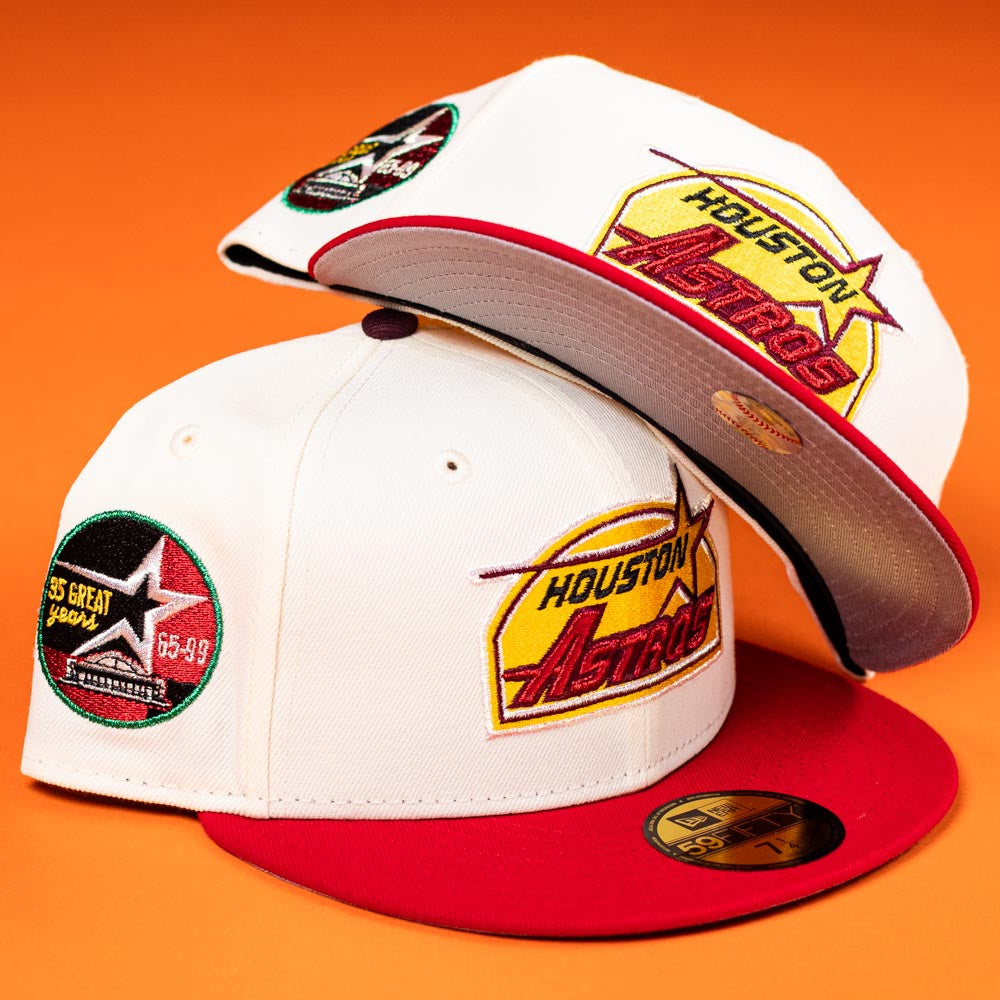 Two white and red Poppa Burger Bo Bundy 35th Houston Astros New Era 5950 Fitted Hats with embroidered logos and commemorative patches, displayed on an orange background.