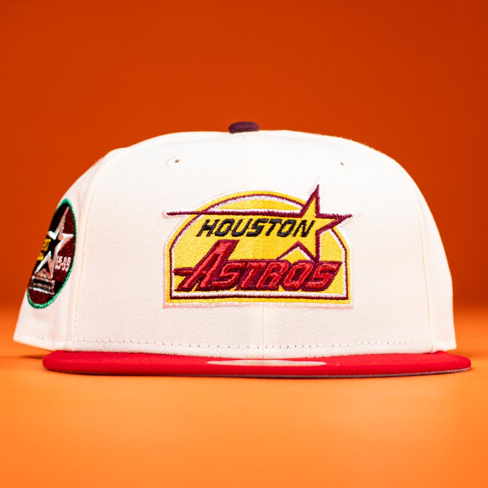 A Poppa Burger Bo Bundy 35th Houston Astros Bo New Era Hat 5950 Fitted in white with a red brim and a yellow, red, and purple logo is shown against an orange background.