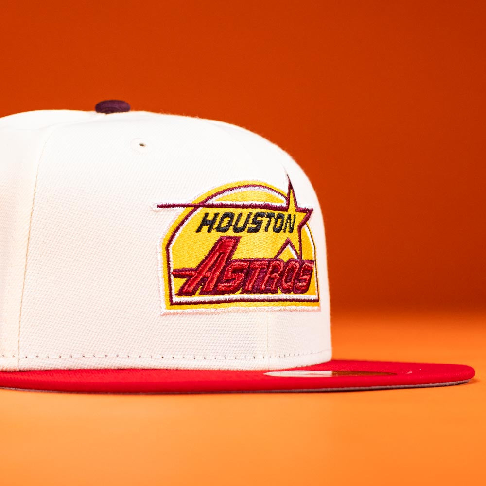 The Poppa Burger Bo Bundy 35th Houston Astros Bo New Era Hat 5950 Fitted, featuring a white crown, red brim, and yellow-red Astros logo, is showcased against an orange background.