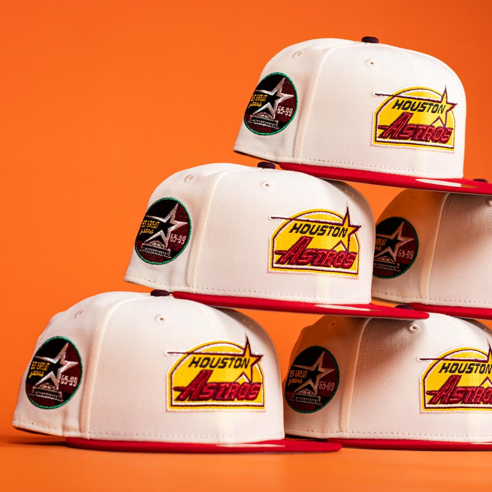 Five Poppa Burger Bo Bundy 35th Houston Astros Bo New Era Hat 5950 Fitted caps are stacked in two rows against an orange background. Each cap features the Astros logo and a commemorative side patch.