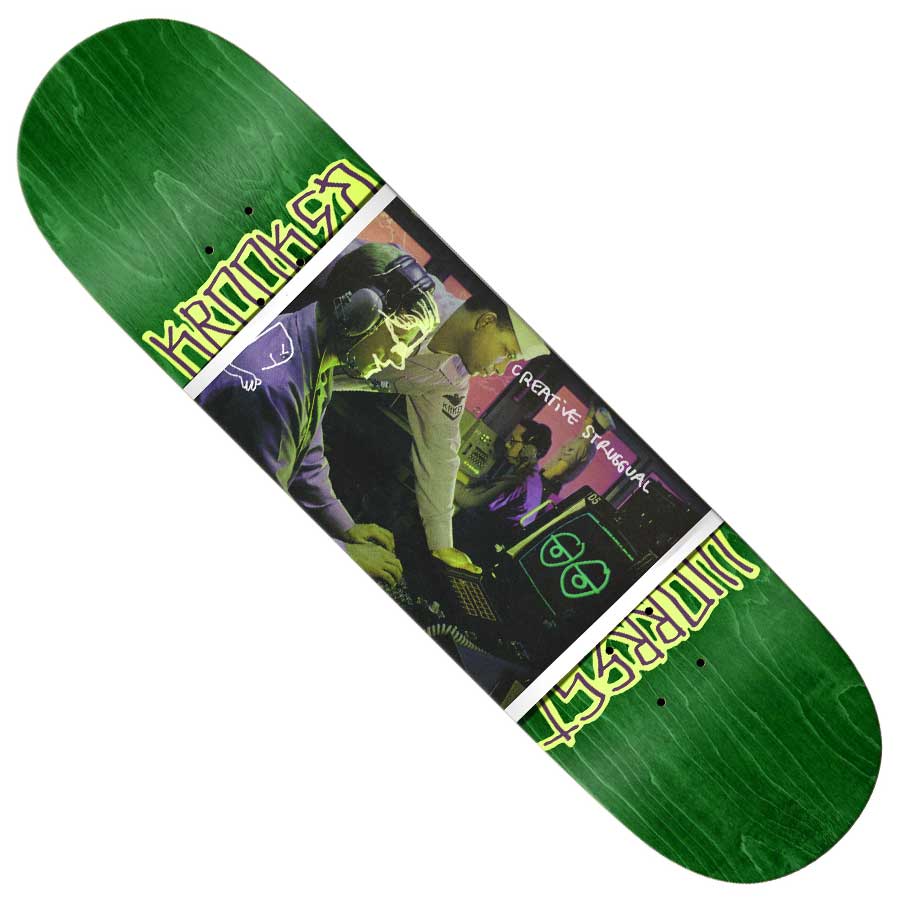 The Bobby Worrest Strgual Twin Tail 8.25x32 Krooked Skateboard Deck in green showcases a photo of two people DJing, yellow graffiti-style text, and "CREATIVE RESIDUAL" in white over the image.