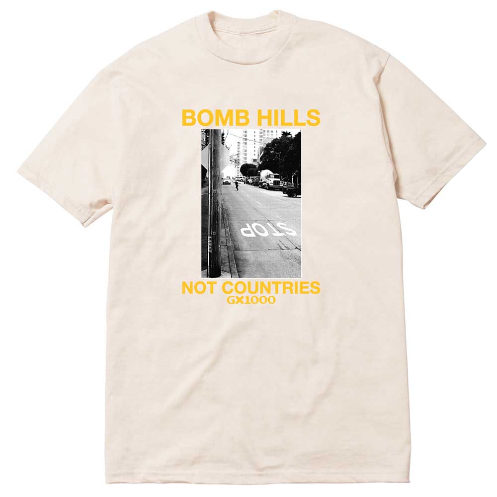 Bomb Hills Not Countries Off White GX1000 Tee Yellow Font showcasing a black-and-white street photo, highlighted by bold yellow “BOMB HILLS NOT COUNTRIES GX1000” text above and below the image.