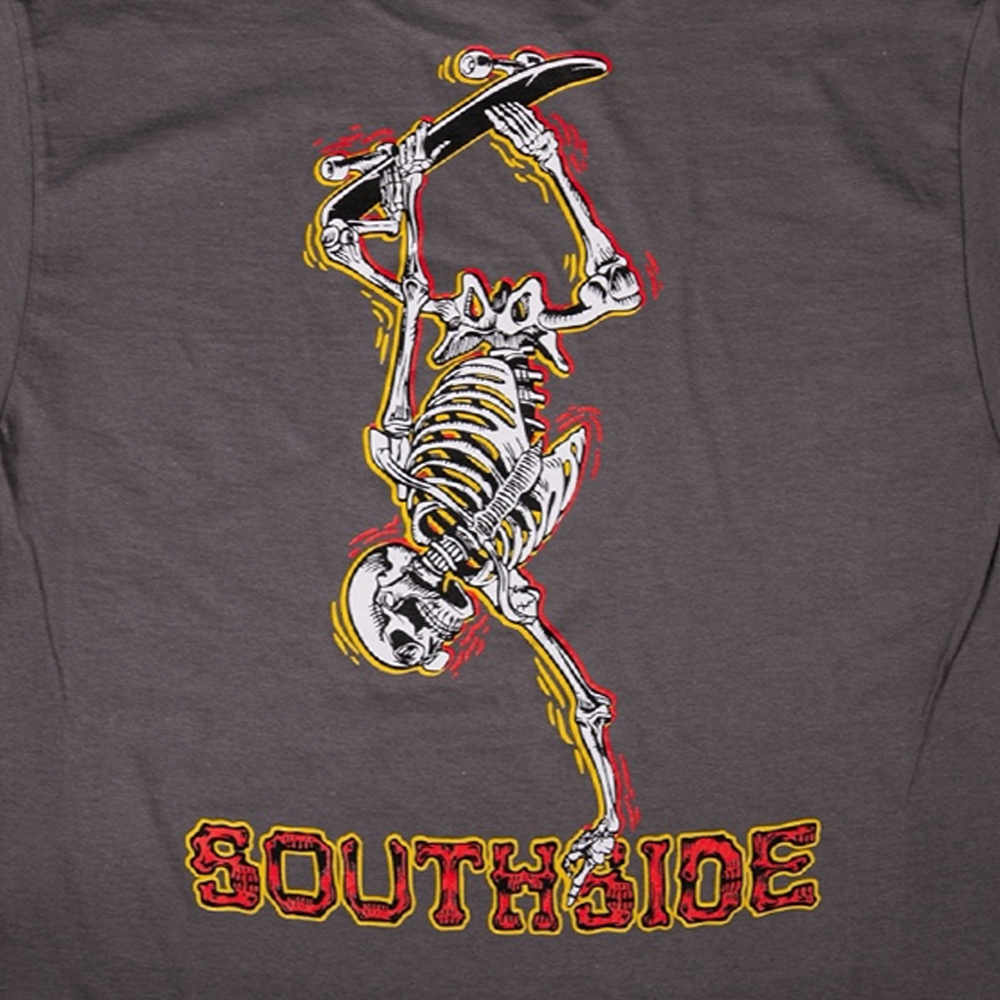 A skeleton skateboarding graphic appears above SOUTHSIDE in bold red and yellow on a dark background, featured on the Bones Pack Ben Raybourn Charcoal Southside Skatepark Tee made from quality USA cotton.