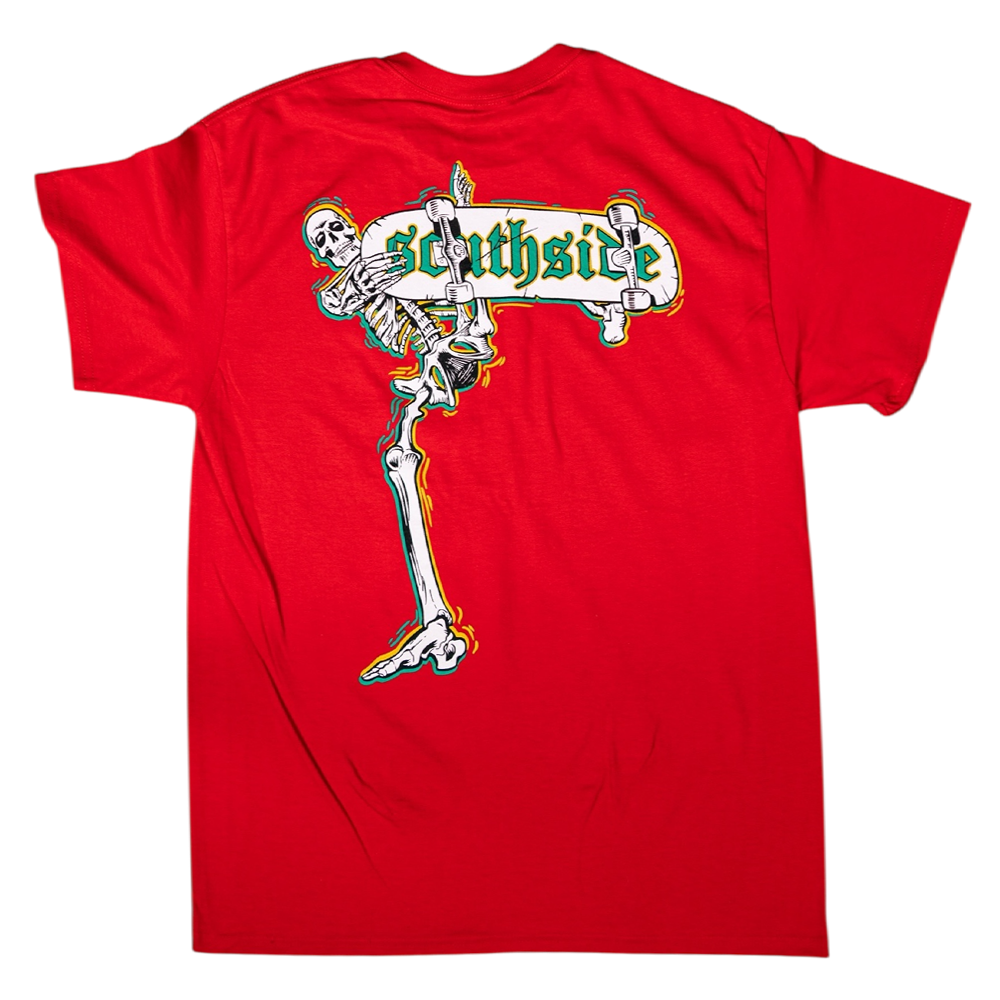 The Bones Pack Zach Castillo Red Southside Skatepark Tee features a large back graphic of a skeleton lounging on a green and yellow Southside sign, with legs stretching down. Made from soft, sustainable cotton for all-day comfort.