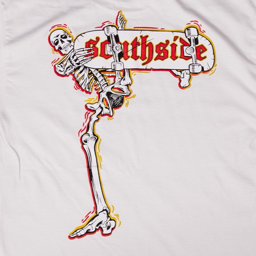 A dynamic skeleton with a skateboard and "Southside" in red, outlined with yellow and red on a light background—printed on sustainable cotton as the Bones Pack Zach Castillo White Southside Skatepark Tee.