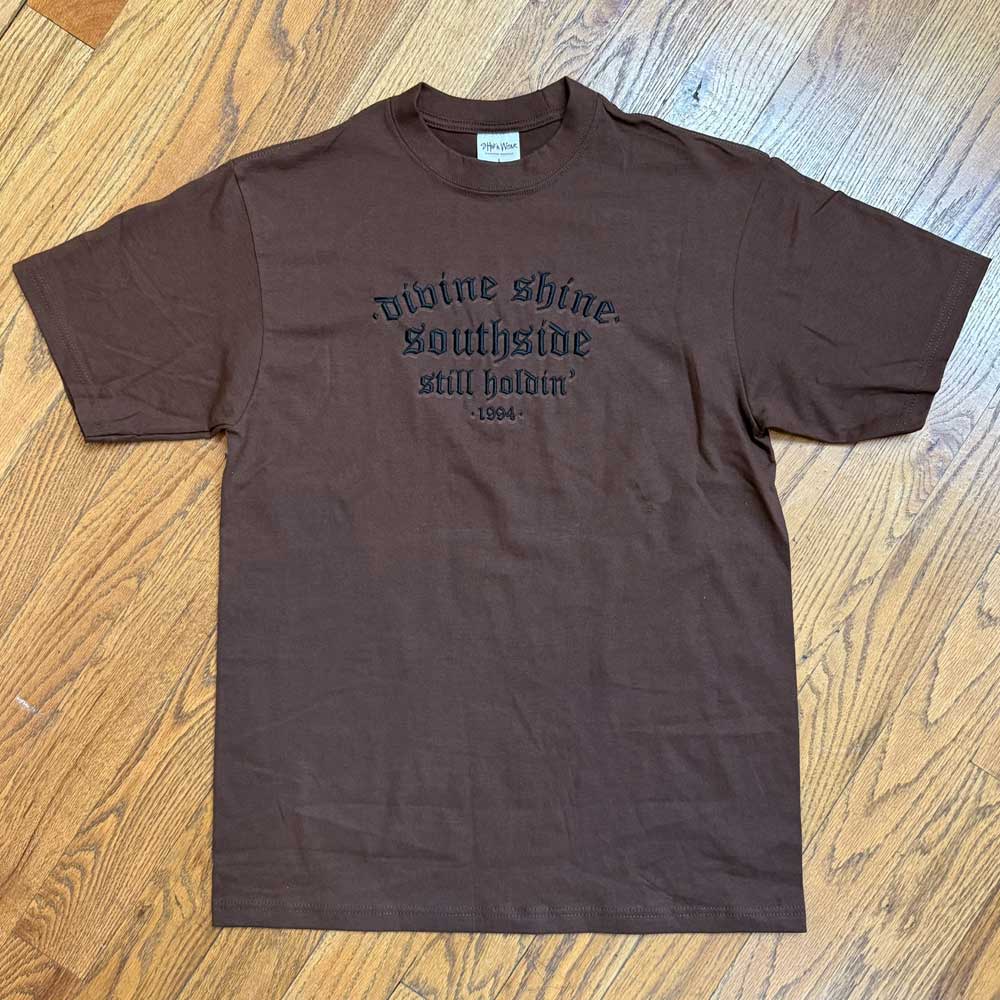 The Brown Divine Shine x Southside Still Holdin Max Heavyweight Tee features black embroidered text and is ideal for streetwear or a session at Southside Skatepark.