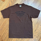 The Brown Divine Shine x Southside Still Holdin Max Heavyweight Tee features black embroidered text and is ideal for streetwear or a session at Southside Skatepark.