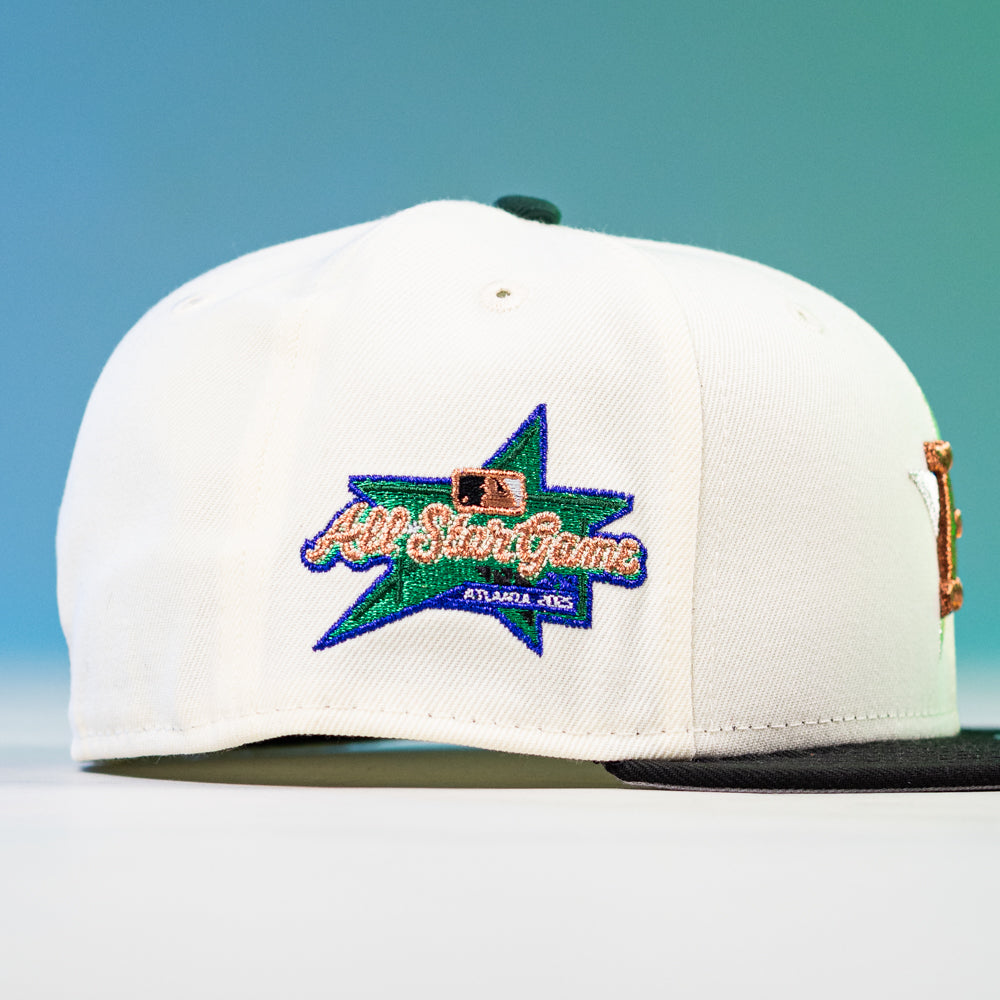 The Houstatlantavegas Chrome Black Green ASG Houston Astros New Era Hat 5950 Fitted features a black brim, embroidered multicolor All-Star Game logo on the side, and stands out against a blue and green gradient background.
