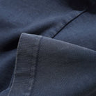 Close-up of the Campus Tee Washed Navy Cash Only shows its visible stitching and seams on durable heavyweight fabric, highlighting the quality and texture of this premium t-shirt.