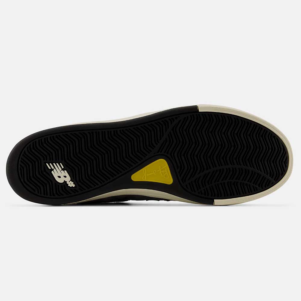 Castlerock Navy Jamie Foy Cup 306 CYZ New Balance Numeric Suede Skateboarding Shoes feature a black rubber outsole with white and yellow accents, showcasing the iconic New Balance logo and a textured grip pattern for superior impact protection—ideal for skateboarding.