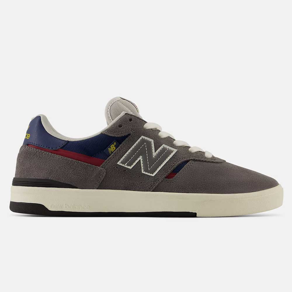 The Castlerock Navy Jamie Foy Cup 306 CYZ New Balance Numeric Suede Skateboarding Shoes feature a classic and sporty design with a durable gray suede upper, white sole, white laces, and stylish navy and red accents. A prominent white "N" logo decorates the side, while a navy heel detail adds extra flair for both style and longevity.