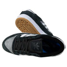 The Centennial 85 Low ADV Black Gray White Adidas Skateboarding Suede features a black and gray suede upper, white stripes, and a gum sole with the Adidas Skateboarding logo; one shoe is shown from the top, the other from the side.