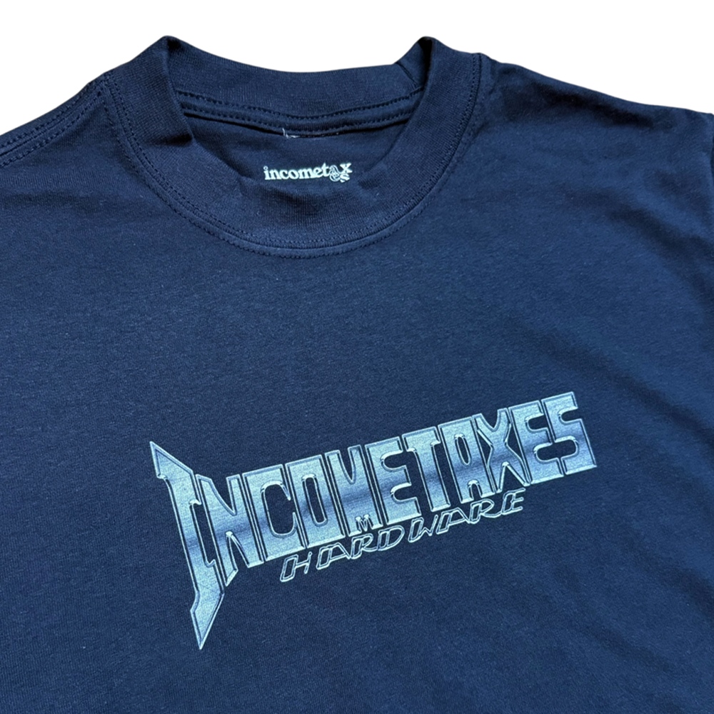 The Chrome Fade Tee Navy Income Taxes is a navy blue streetwear shirt made from premium USA cotton, featuring bold metallic "INCOME TAXES HARDWARE" lettering across the chest and an incometax logo tag, inspired by Houston skateboarding.
