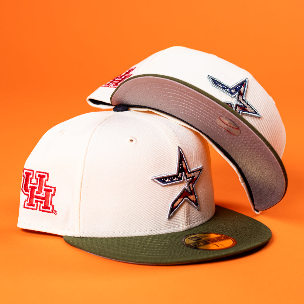 Two Stars Over Houston UH New Era 5950 fitted hats with white crowns and olive green brims sit on an orange background. One shows a red Houston Cougars UH logo; both have a star patch with an American flag on the side.