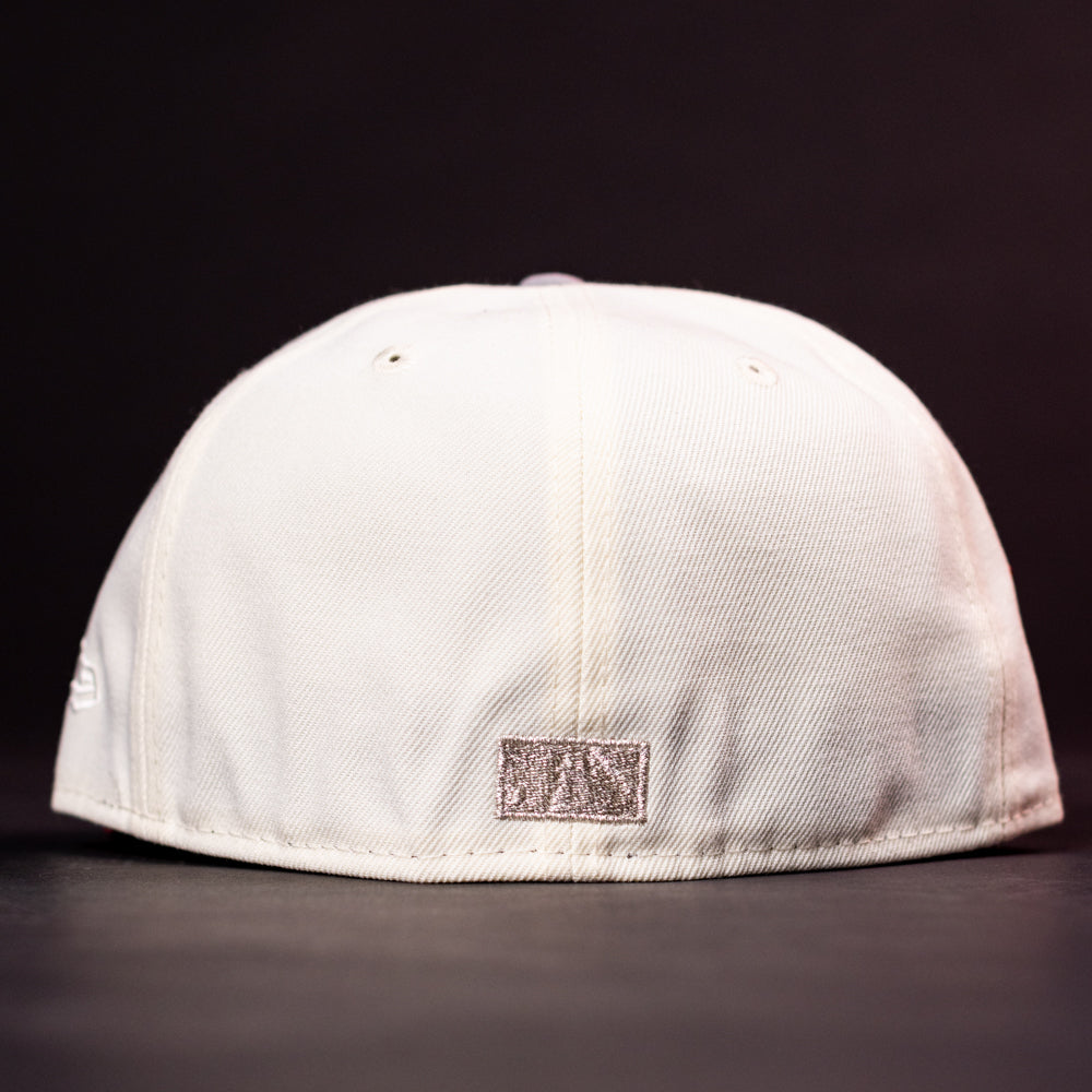 The Carter Chrome Scarlet Houston Cougars New Era Hat 5950 Fitted is displayed from the back against a dark background, highlighting a small rectangular metallic patch at the bottom center and ventilation eyelets on top. This fitted cap combines classic design with subtle Houston Cougars pride.