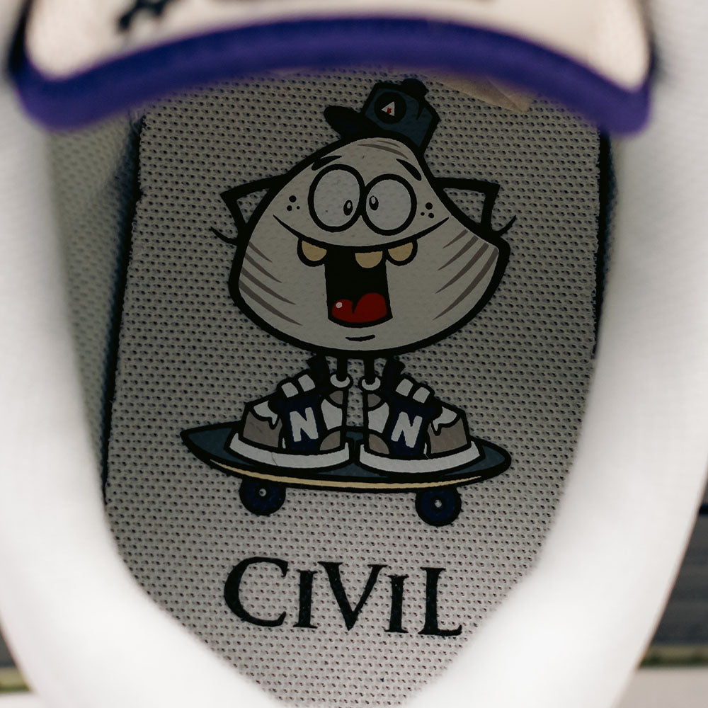 A cartoon character with glasses, a hat, and big teeth rides a skateboard wearing 480 CVL New Balance Numeric x Civil suede leather skateboarding shoes featuring an N logo and ABZORB midsole; “CIVIL” is printed on the insole.