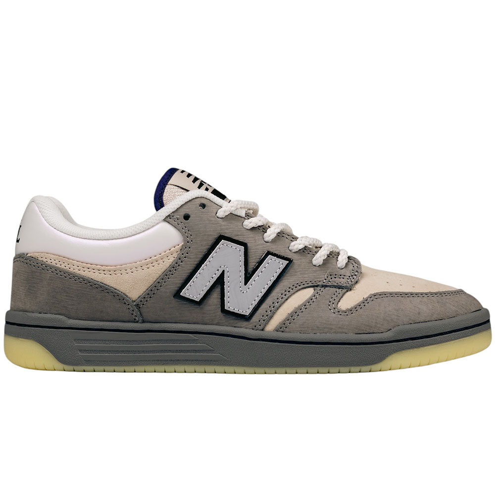 Introducing the 480 CVL New Balance Numeric x Civil Suede Leather Skateboarding Shoes—crafted with a grey and beige suede leather upper, white laces, and a bold black-and-white N logo at the side. These sneakers feature white lining and a translucent rubber sole, providing both durability and style. The ABZORB midsole ensures superior comfort and support, making this versatile design perfect for everyday wear as well as casual skate sessions.