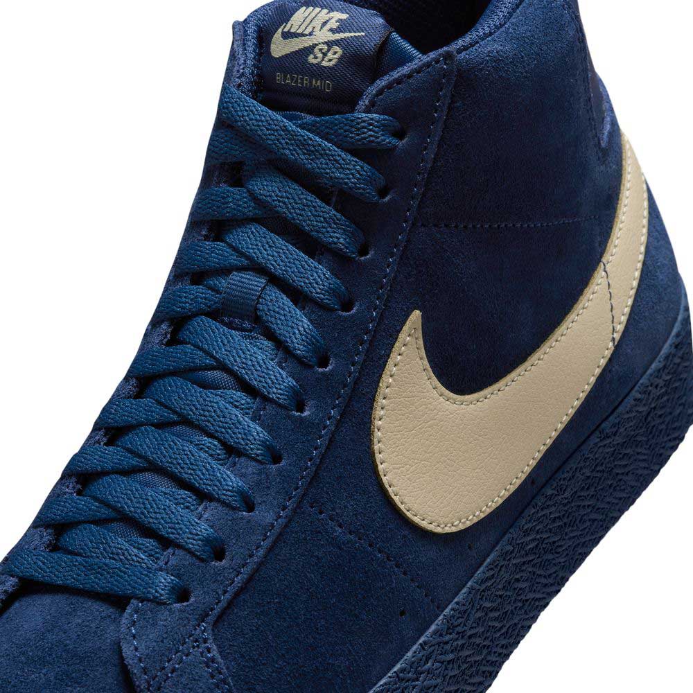 Close-up of Coastal Blue Pale Yellow IO0667400 Blazer Mid Nike SB Suede Skateboarding Shoes, featuring a cream swoosh, matching blue laces, suede upper, and responsive cushioning for comfort.