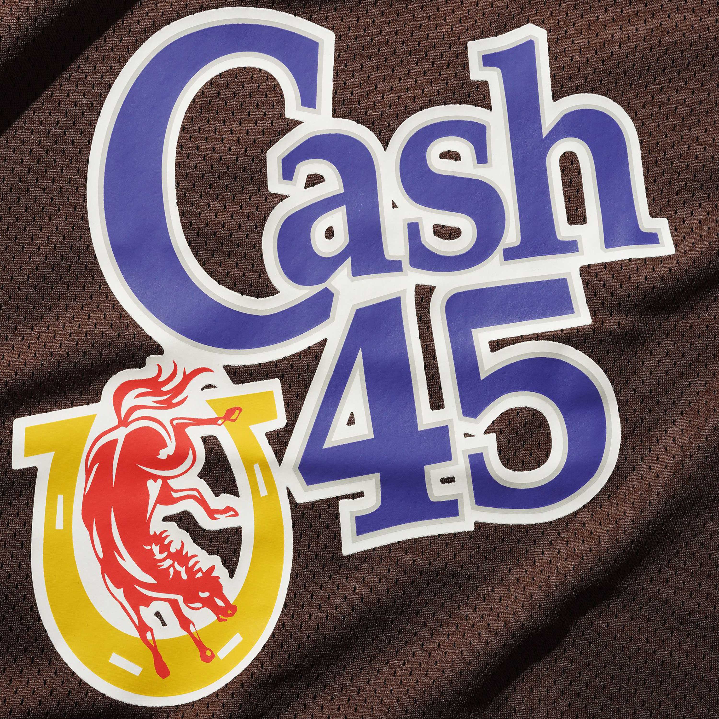 The Colt Jersey Brown Cash Only features "Cash 45" in bold blue and white on brown mesh polyester, with a red bucking horse inside a gold horseshoe below the text.