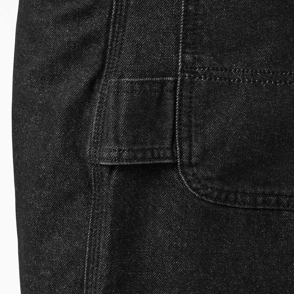Close-up of heavyweight denim with visible stitching and a rectangular flap pocket on the left—an elevated detail featured in the DDSK68 Loose Fit Denim Pant Carpenter Black by Dickies Skateboarding.