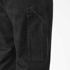 Close-up of DDSK68 Loose Fit Denim Pant Carpenter Black Dickies Skateboarding jeans, focusing on the side pocket and upper thigh, highlighting 5-pocket styling and heavyweight denim texture against a plain light background.