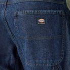 Close-up of the back pocket on DDSK68 Loose Fit Denim Pant Carpenter Dark Wash Dickies Skateboarding jeans, featuring a small rectangular Dickies patch and visible stitching details.