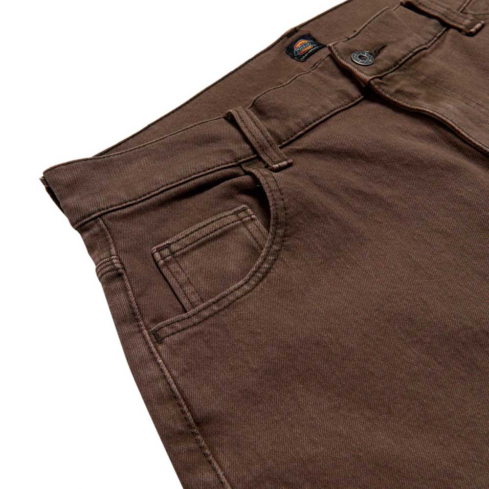 Close-up of the DDSK68J84 Loose Fit Denim Pant in Wingville Brown Tint Wash by Dickies Skateboarding, highlighting the front pocket, coin pocket, waistband, belt loops, and button closure.