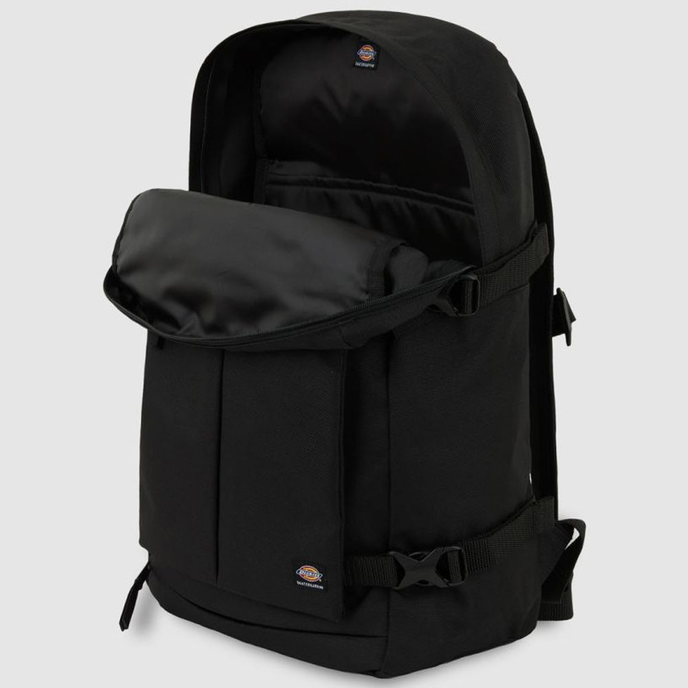The A8675BLK Black Mike Anderson Pro Skate Dickies Skateboard Strap Backpack features a front pocket, skate straps on the sides, a small logo patch on the lower front, and a partially unzipped main compartment. Background is light gray.