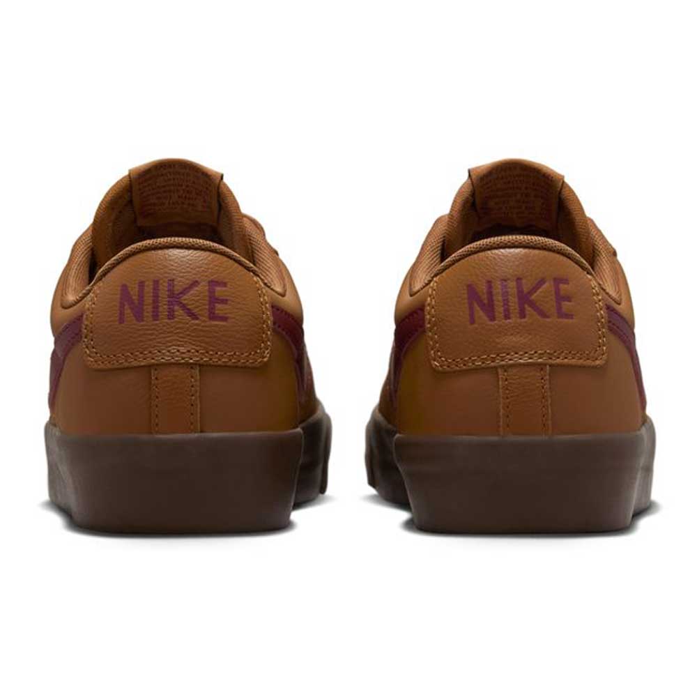 A rear view of the DV1226200 GT Dark Red Brown Blazer Low Nike SB Suede Skateboarding Shoes, featuring purple NIKE text on the heel tabs and dark brown soles—ideal for stylish and high-performance skateboarding.