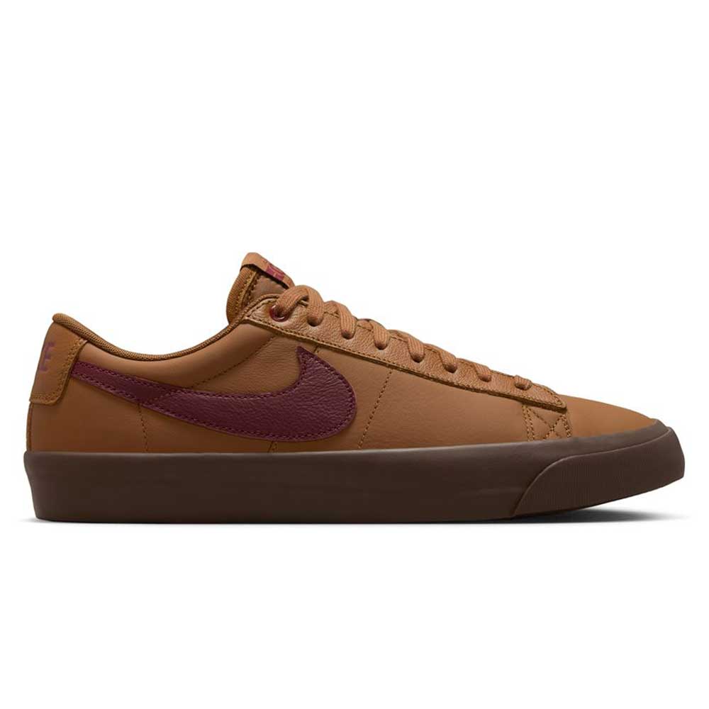 The DV1226-200 GT Dark Red Brown Blazer Low Nike SB Suede Skateboarding Shoes feature a maroon Swoosh, brown laces, and a dark brown rubber sole—an ideal pick for classic skate shoe fans. Displayed in side profile on a white background.